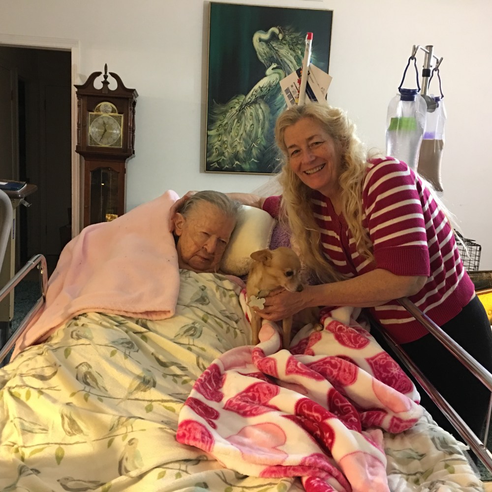 This is my mother Marian at home in a hospital bed with me her daughter Susan and her new rescue dog Foxy in our living room one month before she died in Nov. 2016 after living 8 years at home after a stroke. 