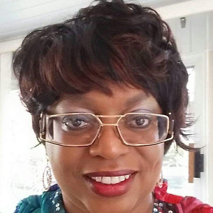 My attached photo is a head shot only of a cute black woman with short, reddish tinted hair, eyeglasses, & a dimple on the cheek.