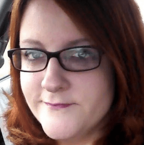 Woman with glasses and a bob. I'm a redhead in a Wonder Woman shirt with an "I Voted" sticker. 